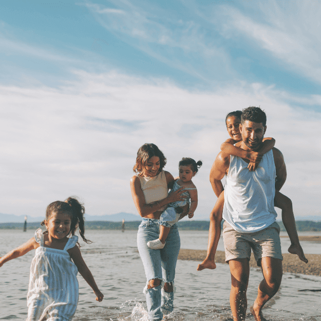 A healthy family on the beach depicting health from eating beef fat