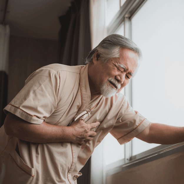 A man clutching his heart questioning the real cause of heart disease